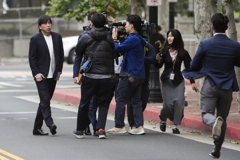 Ippei Mizuhara, left, the former interpreter for the Los Angeles Dodgers baseball star Shohei Ohtani, arrives at federal court in Santa Ana, Calif., Tuesday, June 4, 2024. Mizuhara pleaded guilty to bank and tax fraud on Tuesday and admitted to stealing nearly $17 million from the Japanese baseball player to pay off sports betting debts. AP Photo/Damian Dovarganes)