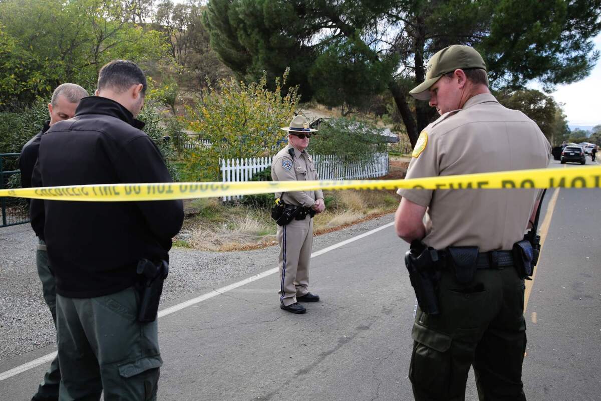 Law enforcement officers investigate at one of several crime scenes after a shooting rampage in Rancho Tehama, Calif.