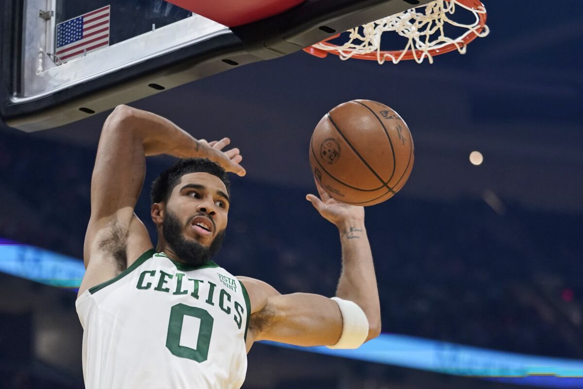 Boston Celtics' Jayson Tatum dunks the ball against the Cleveland Cavaliers in the first half of an NBA basketball game, Monday, Nov. 15, 2021, in Cleveland. (AP Photo/Tony Dejak)