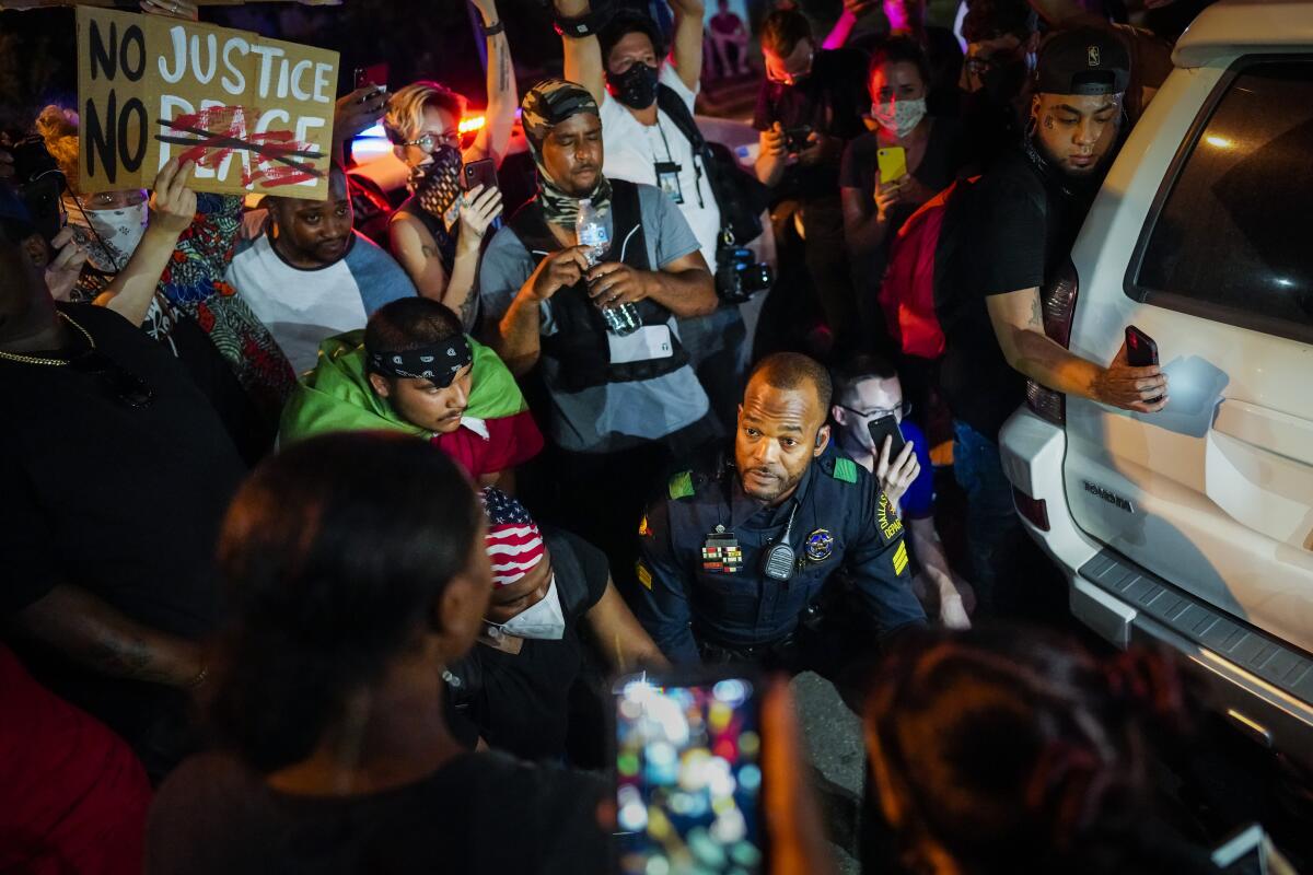A Dallas police officer talks with protestors on June 2.
