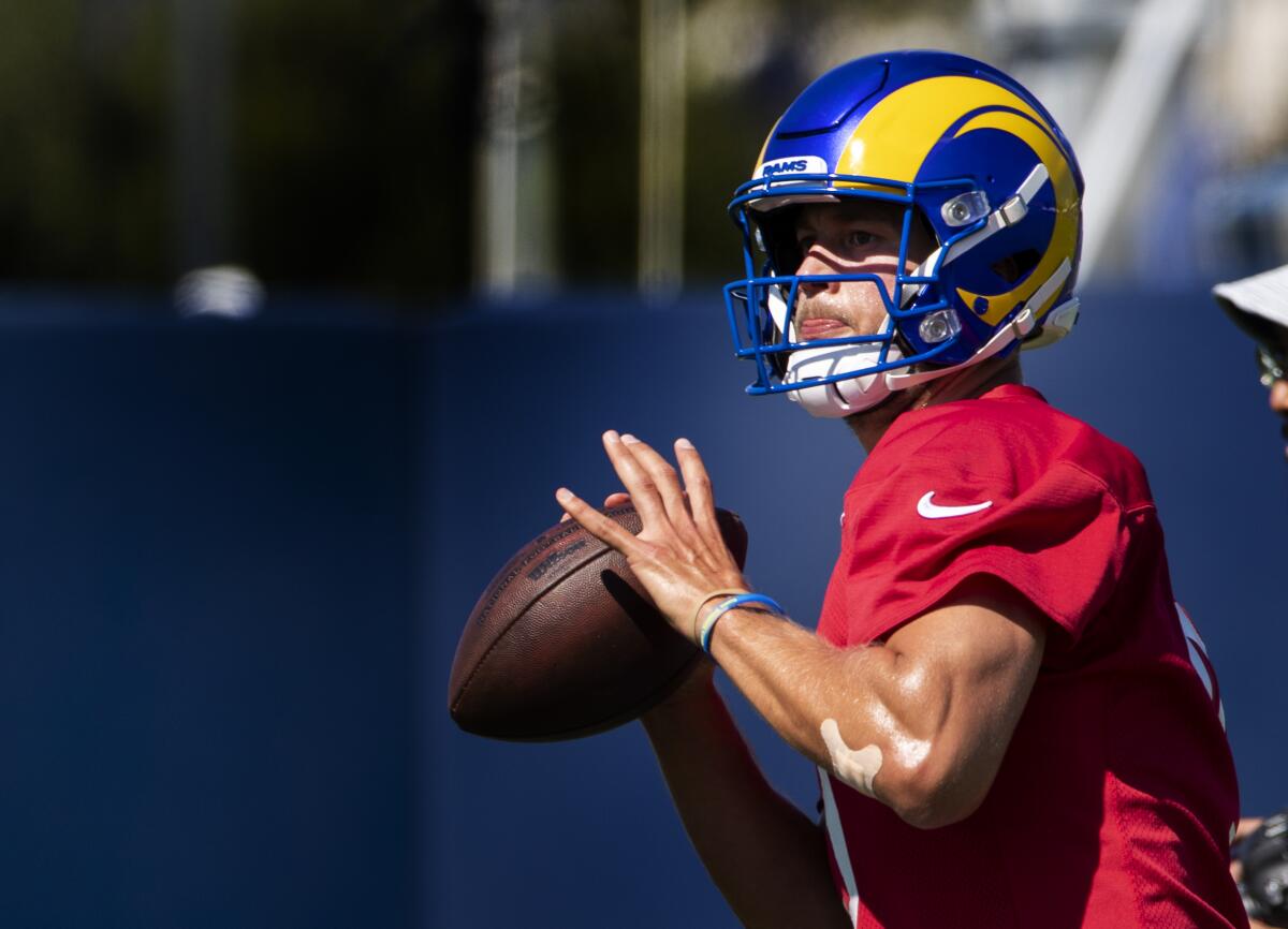 Rams starting quarterback Matthew Stafford looks to pass during camp practice.