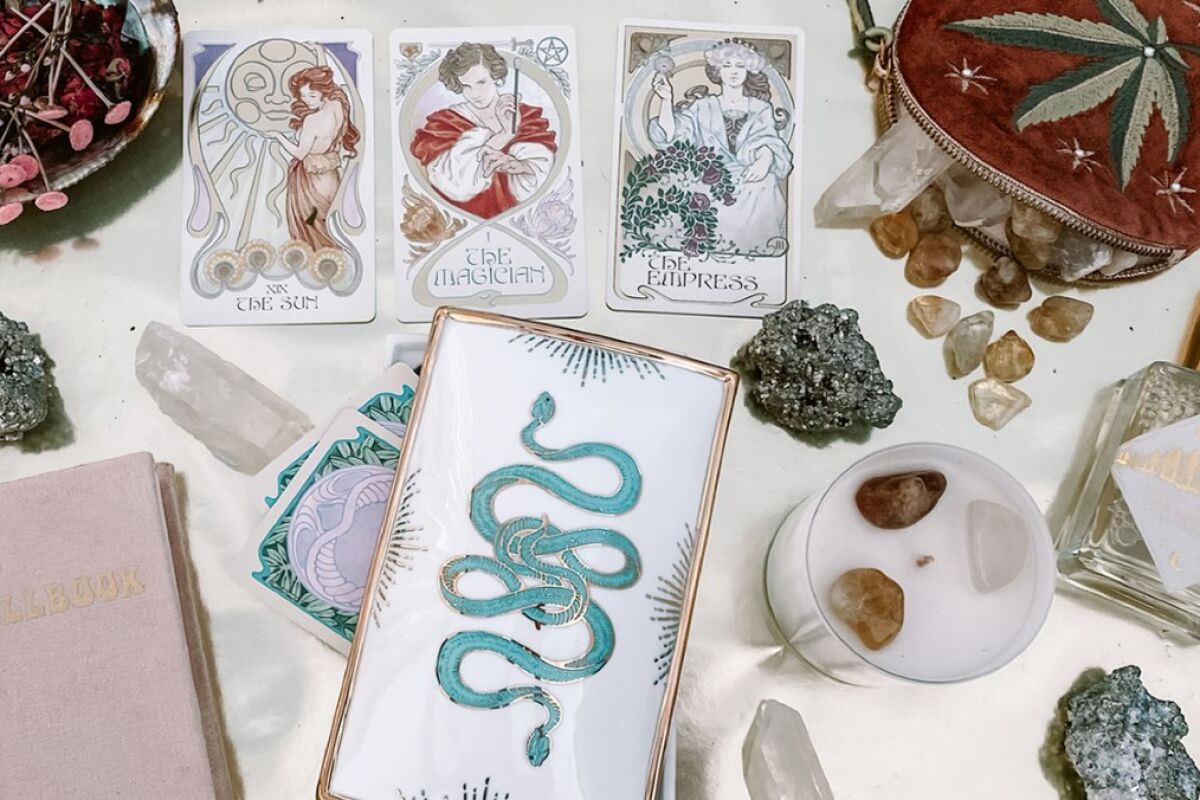An  assortment of tarot cards, crystals and candles.