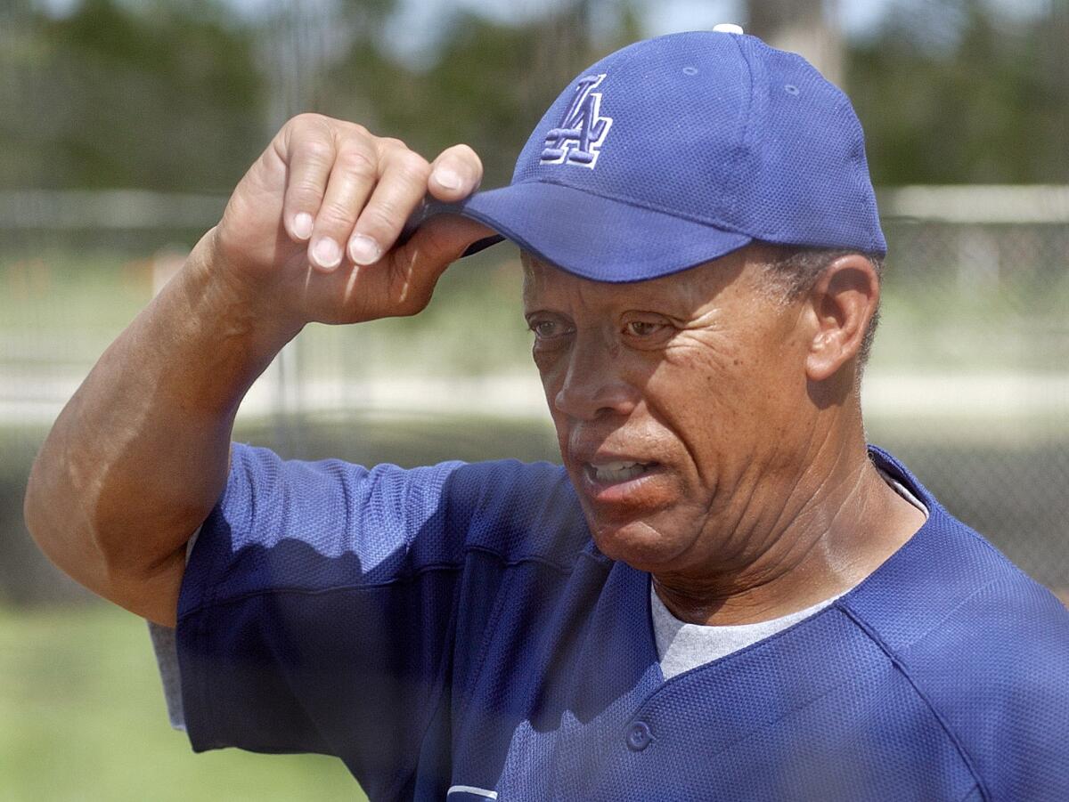 Dodgers bunting and base running coordinator Maury Wills adjusts his cap during spring training at Dodgertown.