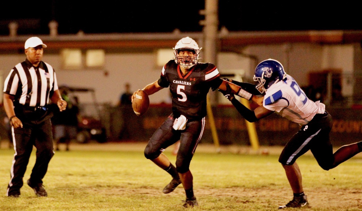 Cleveland quarterback Emiliano Lopez tries to elude Palisades defensive end Immanuel Robinson on Sept. 16, 2022.