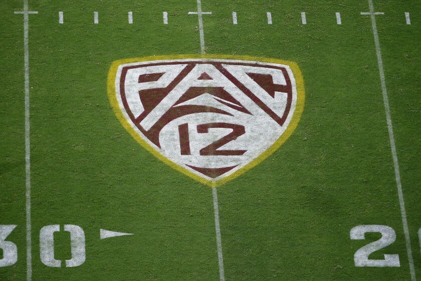 FILE - This Aug. 29, 2019, file photo shows the PAC-12 logo at Sun Devil Stadium during second half of an NCAA college football game between Arizona State and Kent State in Tempe, Ariz. There are 130 major college football teams, spread across 41 states and competing in 10 conferences, save for a handful of independents. The goal is to have all those teams start the upcoming season at the same time — whether that's around Labor Day as scheduled or later — and play the same number of games.(AP Photo/Ralph Freso, File)