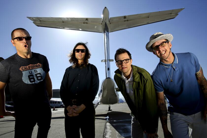 Patrick Wilson, left, Brian Bell, Rivers Cuomo and Scott Shriner of Weezer on the tarmac at Hawthorne Airport last year.