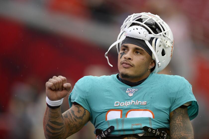 Miami Dolphins wide receiver Kenny Stills (10) greets fans before the start of an NFL preseason football game against the Tampa Bay Buccaneers Friday, August 16, 2019, in Tampa, Fla. (AP Photo/Jason Behnken)
