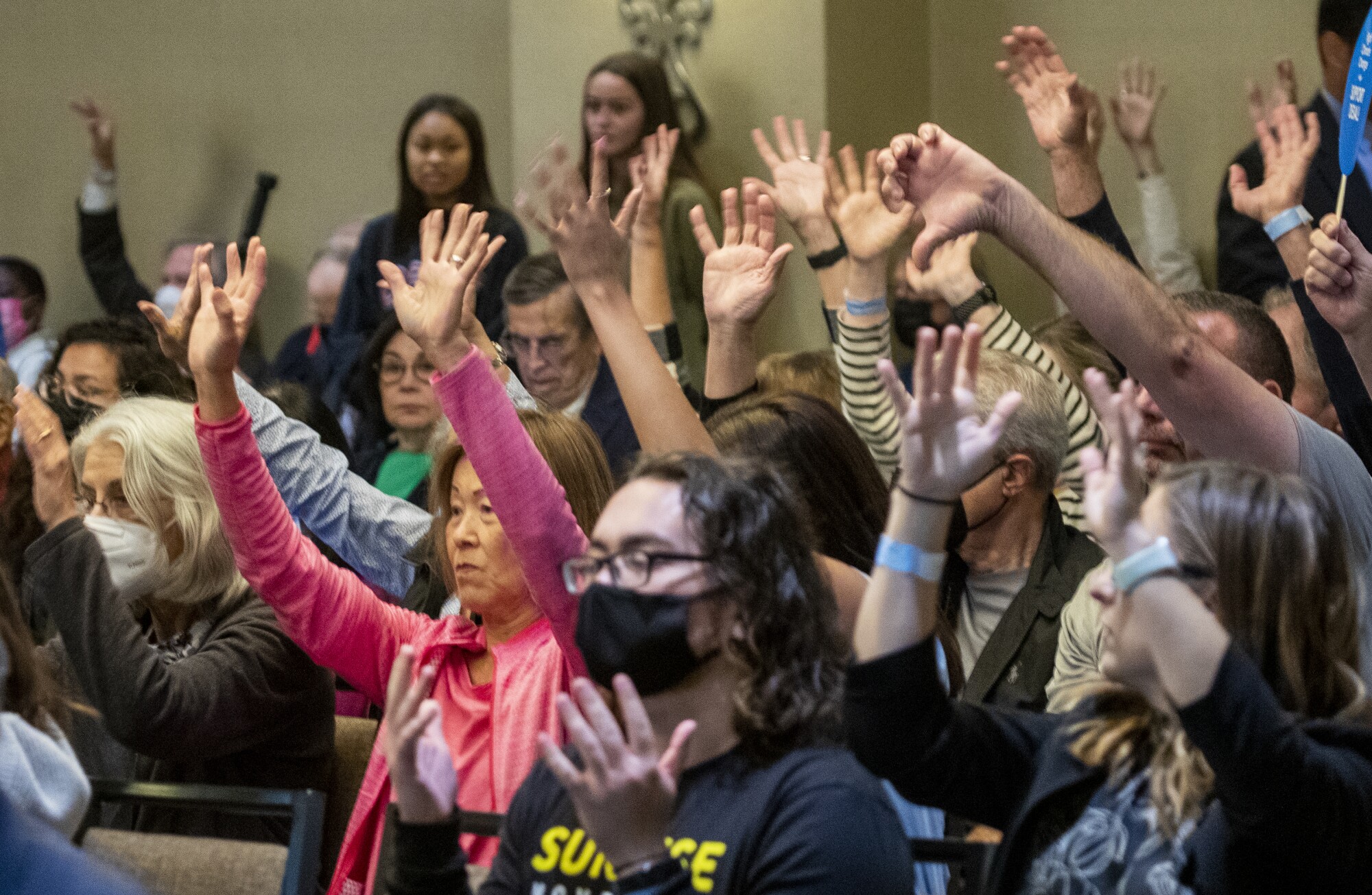 Audience members show their support for for a speaker against the proposed Poseidon desalination plant 