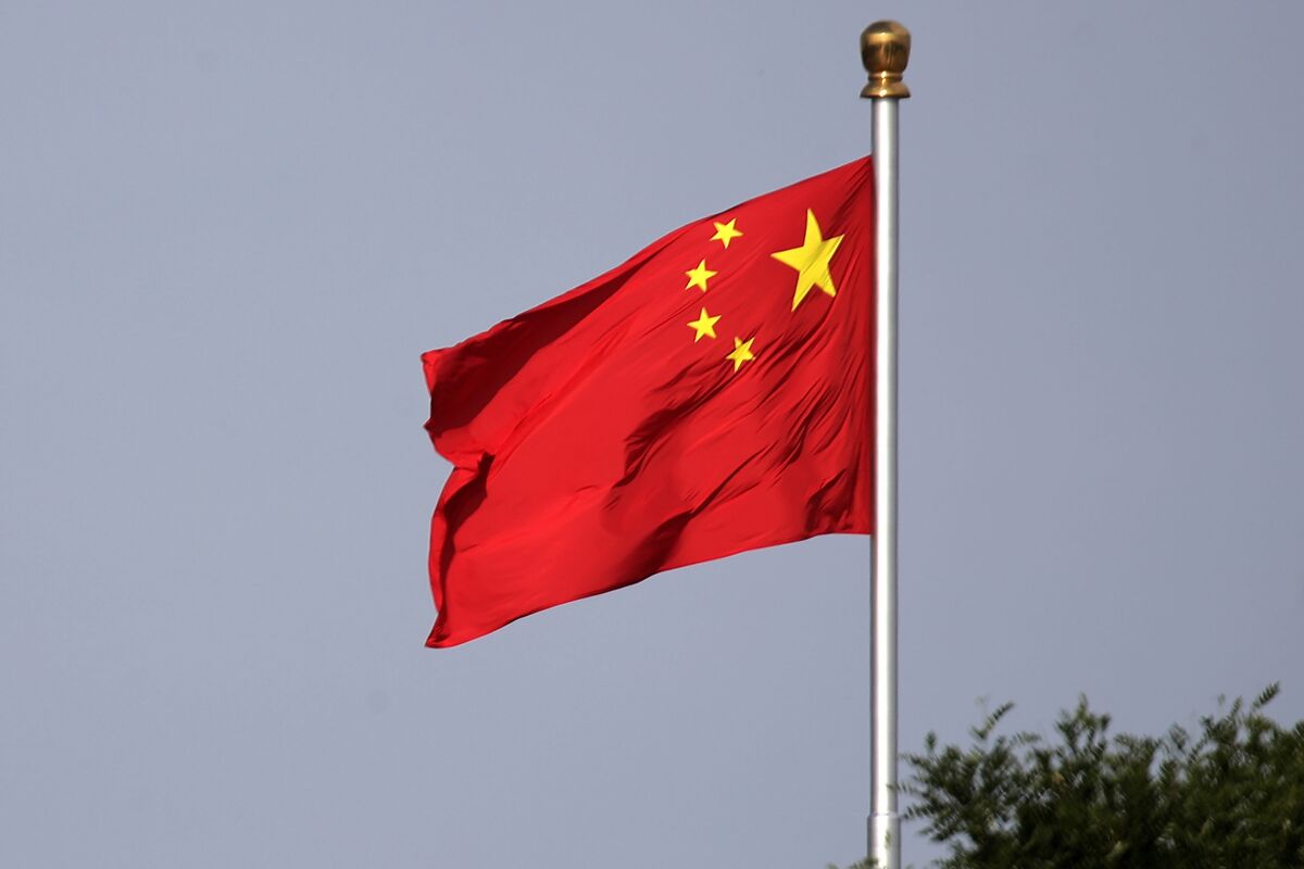 FILE - A Chinese national flag flies at Tiananmen Square in Beijing Thursday, June 14, 2018. A court in northern China sentenced one man to 24 years in jail Friday, Sept. 23, 2022, for his role in a vicious attack on four women, as well as other crimes including robbery and opening an illegal gambling ring. (AP Photo/Andy Wong, File)