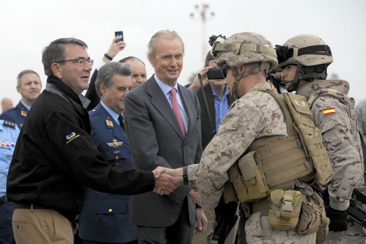 Defense Secretary Ashton Carter, left, and a U.S. Marine flank Spanish Defense Minister Pedro Morenes during a visit to Moron air base in Spain.