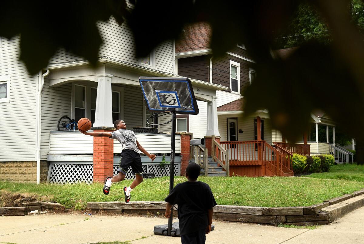 Ken Chapman, 13, attempts a dunk on a street in LeBron James' hometown of Akron, Ohio.