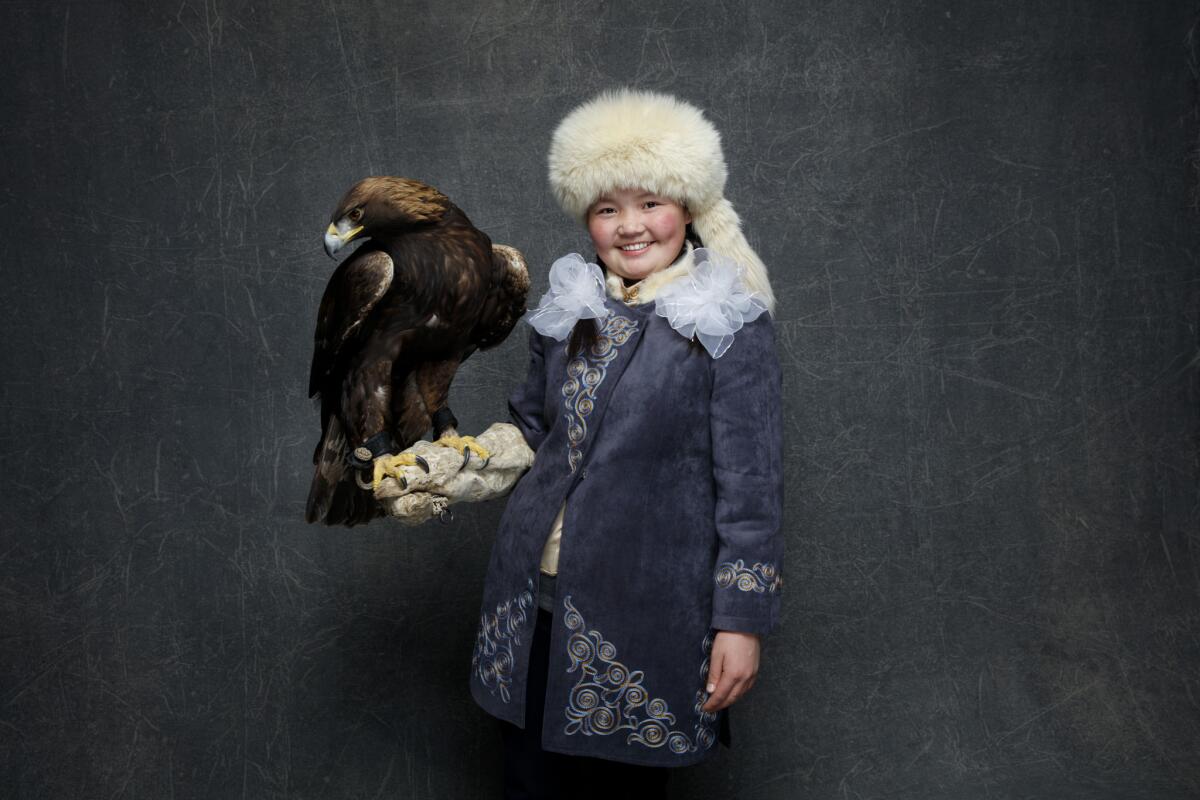 "The Eagle Huntress'" Aisholpan holding Nuepi, the Golden Eagle, in the L.A. Times photo studio at the Sundance Film Festival on Jan. 22.