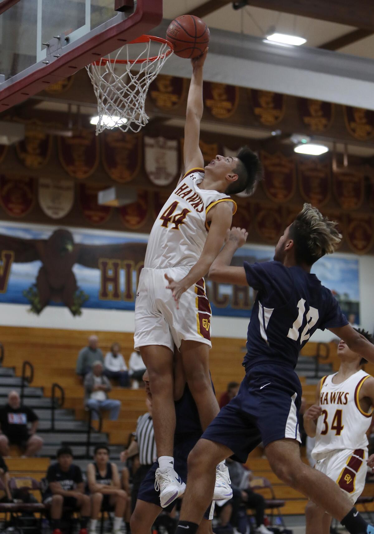 Ocean View's Chico Lopez attempts a dunk as he draws a foul on Central City Value's Pedro Martinez during the first half of a Jim Harris Classic first-round game on Tuesday.