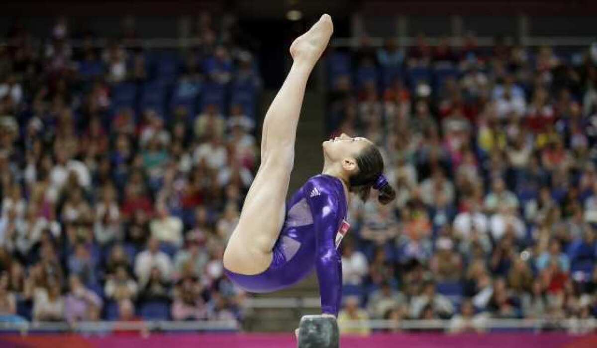 Kyla Ross performs on the balance beam.
