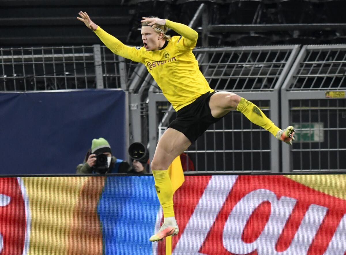 Dortmund's Erling Haaland celebrates after scoring his sides second goal during the Champions League, round of 16, second leg soccer match between Borussia Dortmund and Sevilla FC in Dortmund, Germany, Tuesday, March 9, 2021. (Bernd Thissen/Pool via AP)