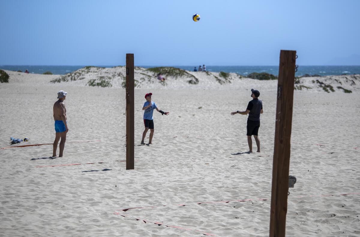 Beachgoers hit a volleyball around at Harbor Cove Beach in Ventura on May 2.
