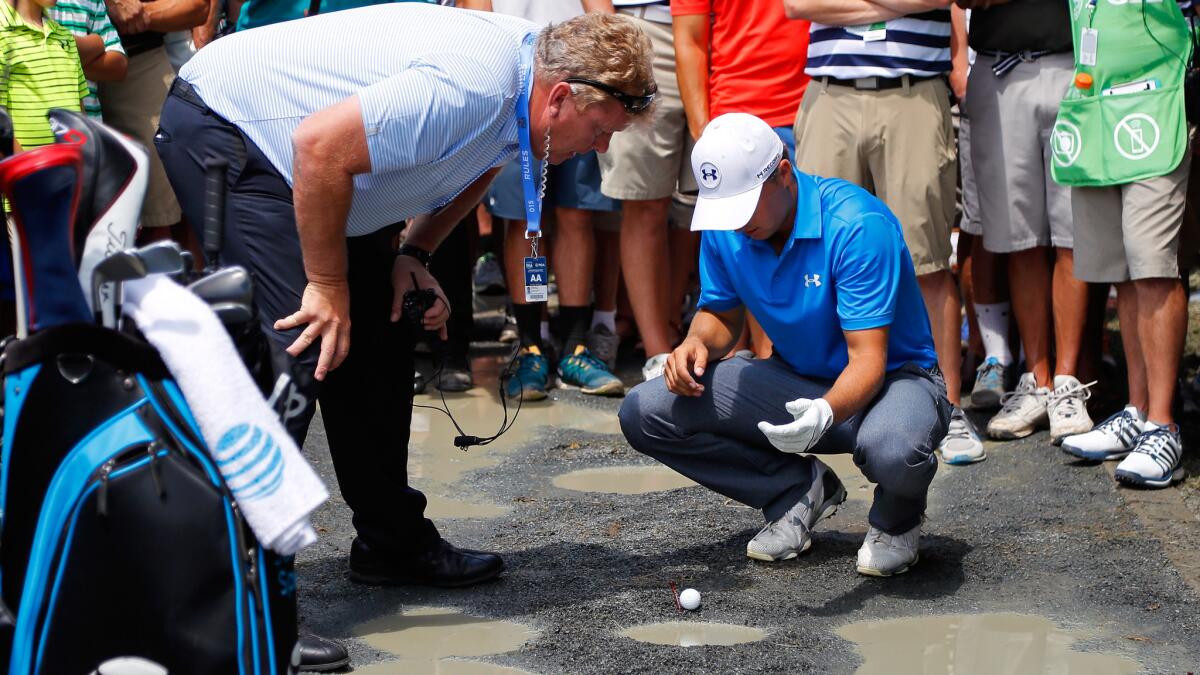 Jordan Spieth discusses where his ball lies on a cart path on the seventh hole with official Brad Gregory on Friday during the second round of the PGA Championship.