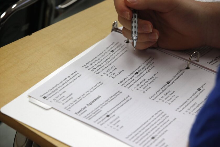 A student looks at questions during a college test preparation class.