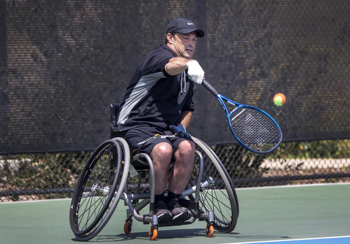 Paralympian David Wagner serves during a U.S. Tennis Assn. event for youth players at Great Park in Irvine.