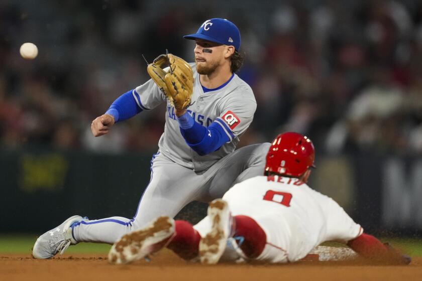 Los Angeles Angels' Zach Neto (9) steals second ahead of a throw to Kansas City Royals shortstop.