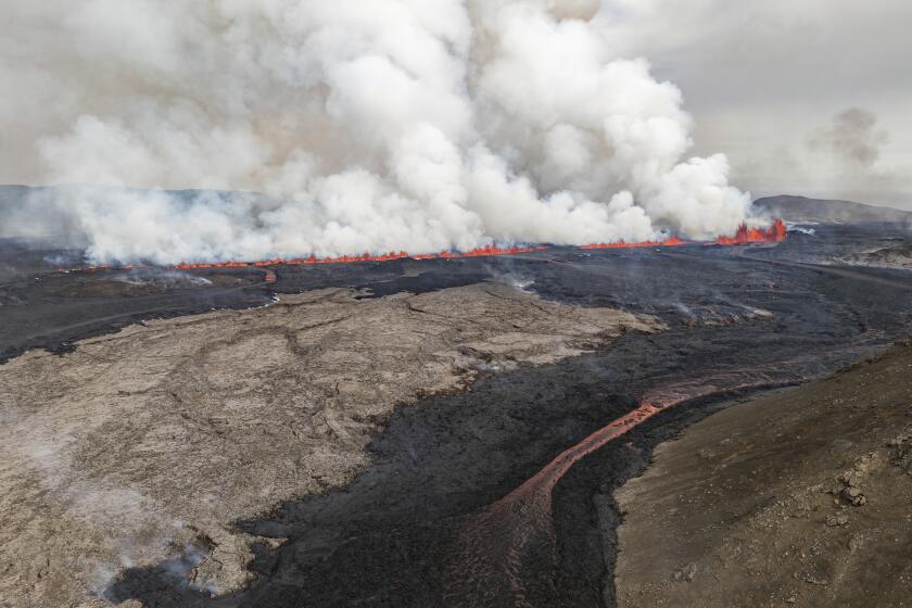 An eruptive fissure spews lava and smoke from a volcano in Grindavik, Iceland, Wednesday, May 29, 2024. A volcano in southwestern Iceland erupted Wednesday for the fifth time since December, spewing red lava that once again threatened the coastal town of Grindavik and led to the evacuation of the popular Blue Lagoon geothermal spa. (AP Photo/Marco di Marco)