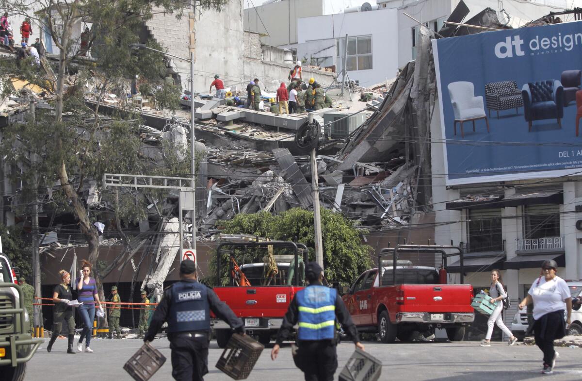 People try to rescue survivors from a collapsed building in Mexico City on Tuesday.