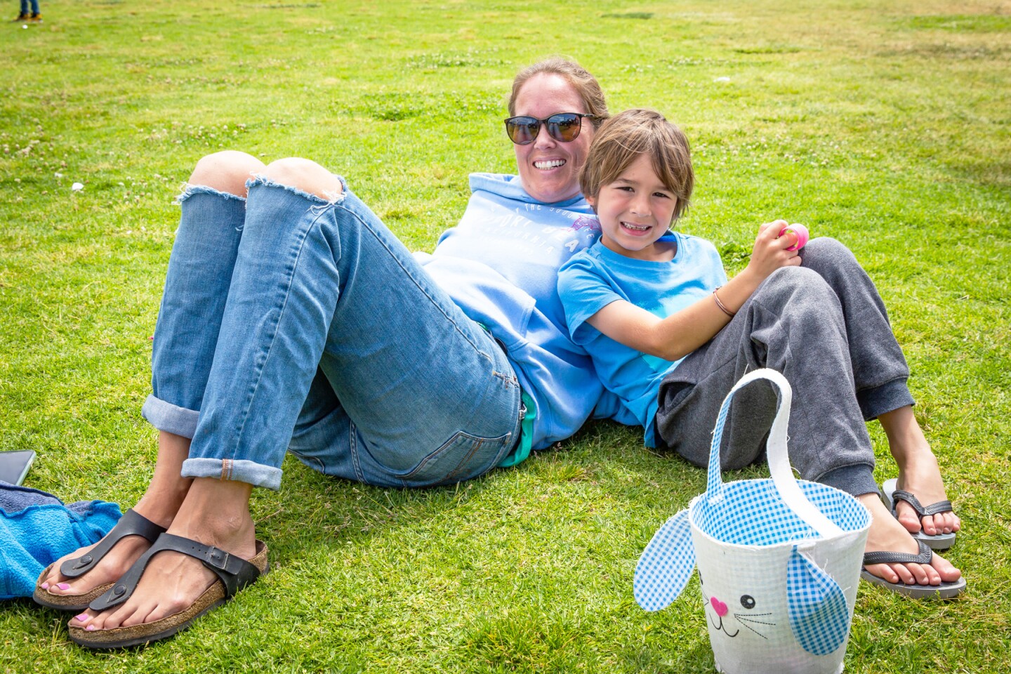 Greta Aiken and Joaquin Sebastian Aiken, 6, relaxing on the grass.