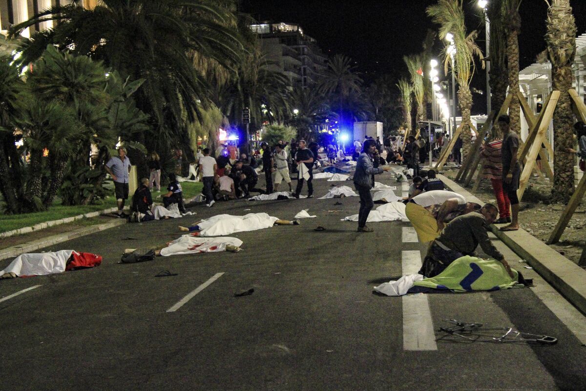 Bodies lie on the street after a truck plowed through a crowded seaside promenade in Nice, France. (Antoine Chauvel / For The Times)