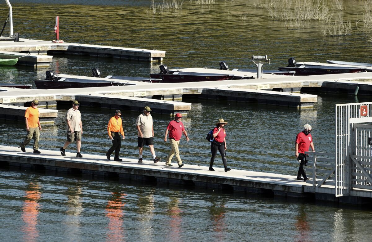 Search and rescue personnel exit the pier at Lake Piru in Los Padres National Forest, Calif., Thursday, July 9, 2020. Authorities said Thursday that they believe "Glee" star Naya Rivera drowned in the lake but they are continuing the search for her a day after her 4-year-old son was found alone in a rented boat. (AP Photo/Chris Pizzello)