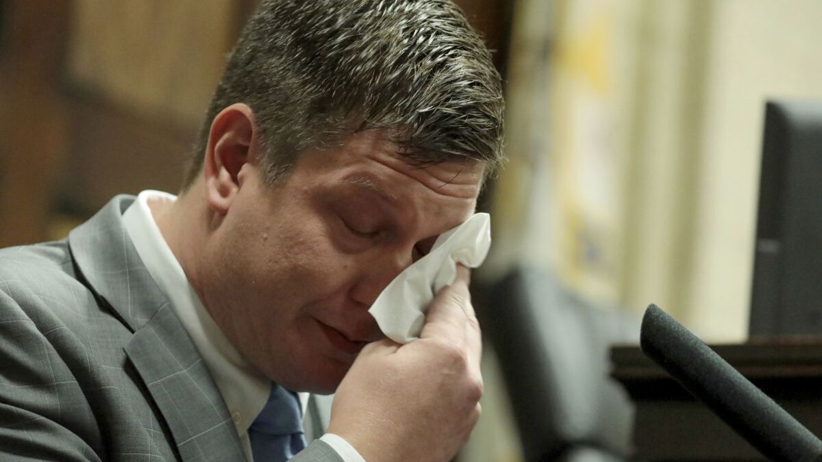 Chicago Police Officer Jason Van Dyke dabs his eyes as he testifies in his murder trial Tuesday in Chicago.