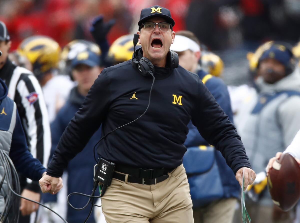 Michigan Coach Jim Harbaugh argues a call on the sideline during the first half against the Ohio State Buckeyes on Nov. 26.