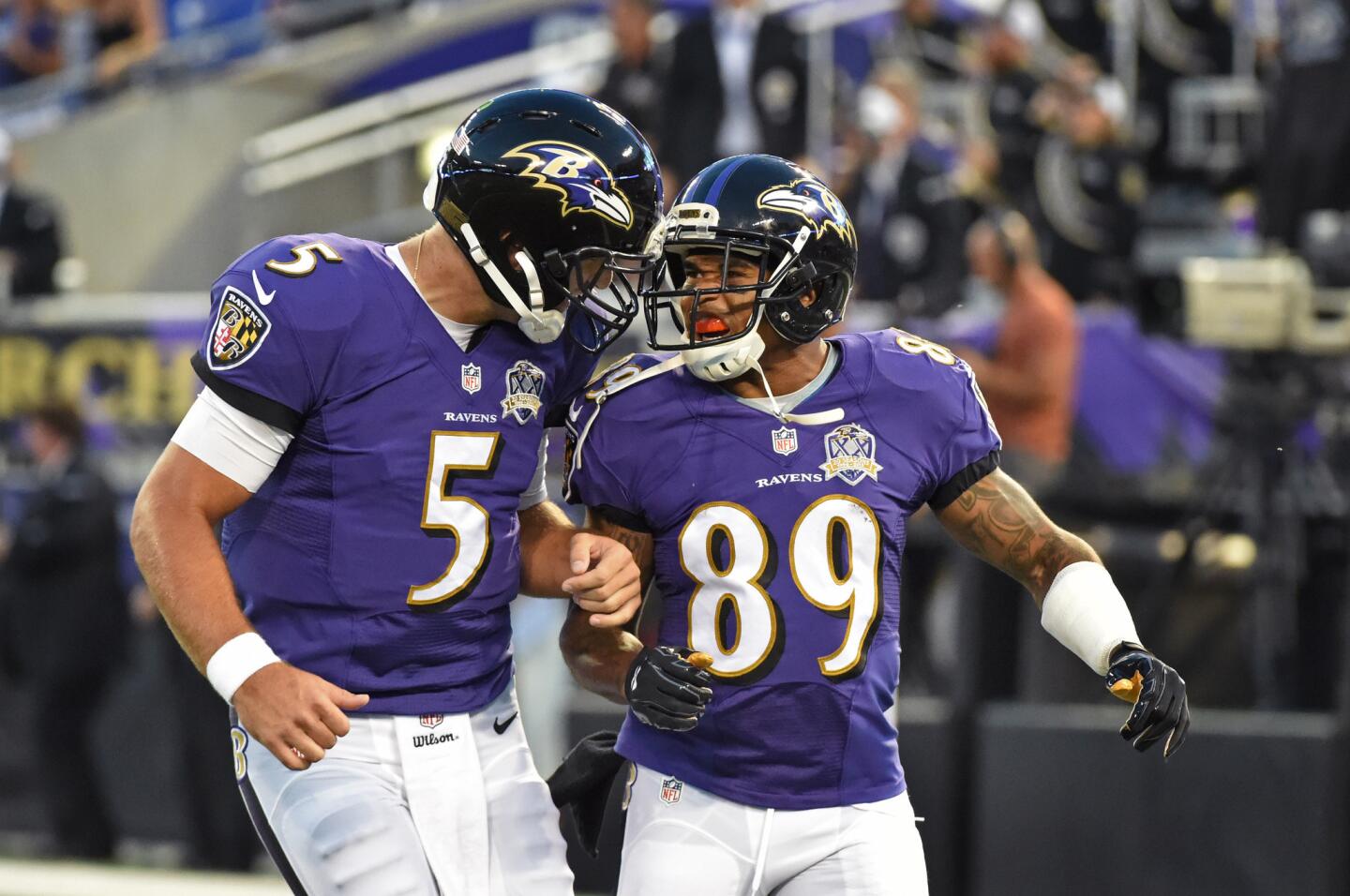 Ravens quarterback Joe Flacco, left, celebrates with wide receiver Steve Smith Sr., after the two connected for a 63-yard touchdown.