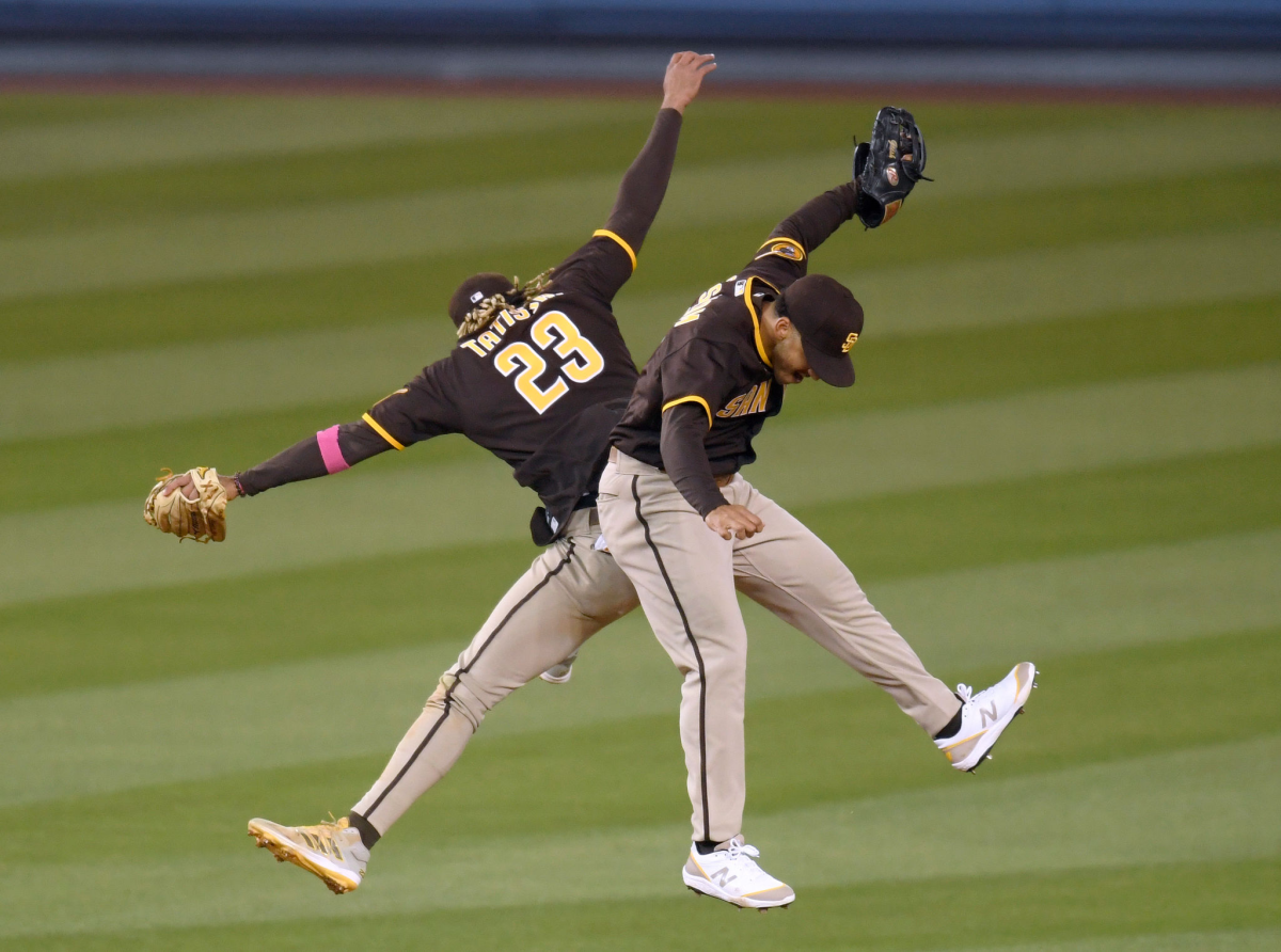 Padres teammates Fernando Tatis Jr., left, and Trent Grisham celebrate San Diego's win over the Dodgers on Sunday.