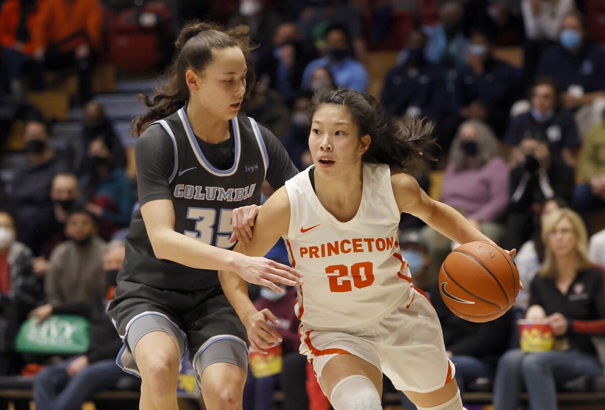 Princeton guard Kaitlyn Chen (20) drives past Columbia guard Abbey Hsu (35) during the first half of an NCAA Ivy League women's college basketball championship game, Saturday, March 12, 2022, in Cambridge, Mass. (AP Photo/Mary Schwalm)