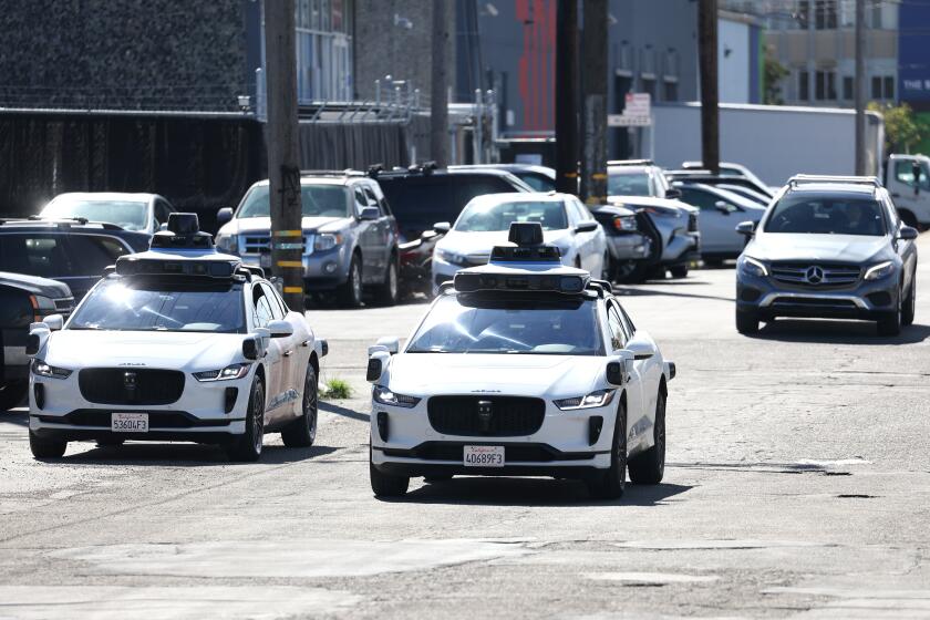 SAN FRANCISCO, CALIFORNIA - MARCH 01: Waymo cars drive down a street on March 01, 2023 in San Francisco, California. Waymo, Alphabet's self-driving car division, announced that it has laid off over 135 employees in a second round of layoffs this year. Waymo has cut 8 percent of its workforce this year. (Photo by Justin Sullivan/Getty Images)