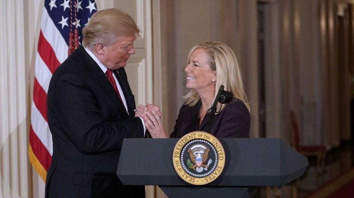 President Trump clasps hands with Kirstjen Nielsen at the White House after nominating her to be Homeland Security secretary on Oct. 12, 2017.
