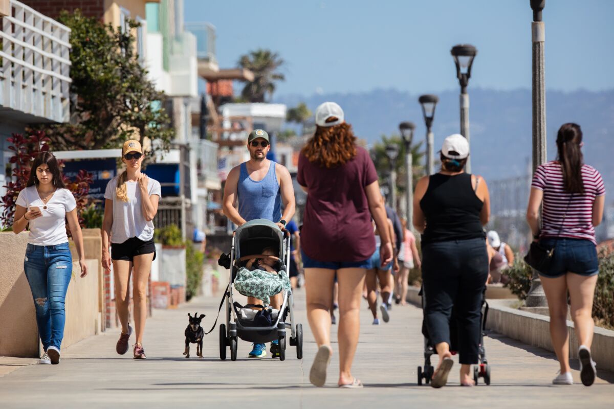People take advantage of the newly opened walking path on the Strand in Manhattan Beach last month.