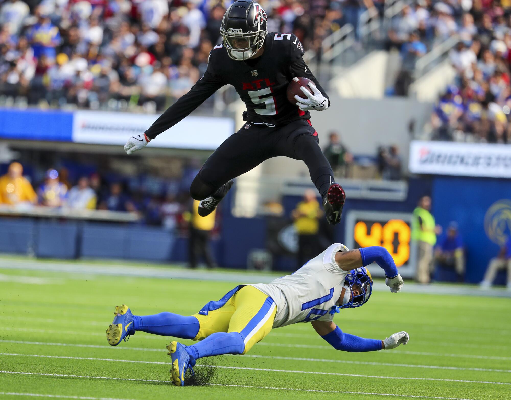Falcons wide receiver Drake London leaps over Rams defensive back Cobie Durant in the fourth quarter.