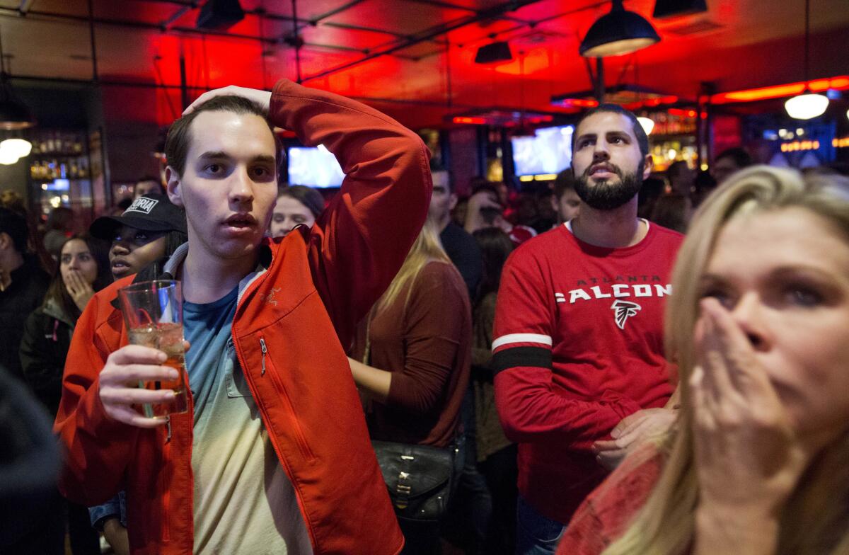 Stunned Atlanta Falcons fans react after their team's loss to the New England Patriots in Super Bowl LI.