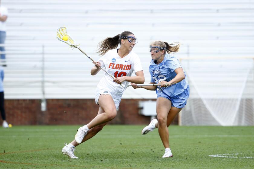 This photo provided by UAA Communications shows Florida attacker Danielle Pavinelli, left, playing against North Carolina in the opening round of the NCAA women's lacrosse tournament, Friday, May 10, 2024, in Charlottesville, Va. The unseeded Gators (20-2) are looking to crash a final four party typically reserved for traditional lacrosse powers. They play top-seeded and defending national champion Northwestern in the first semifinal Friday in Cary, North Carolina. No. 2 seed Boston College and third-seeded Syracuse square off in the other. (UAA Communications/Keith Lucas)