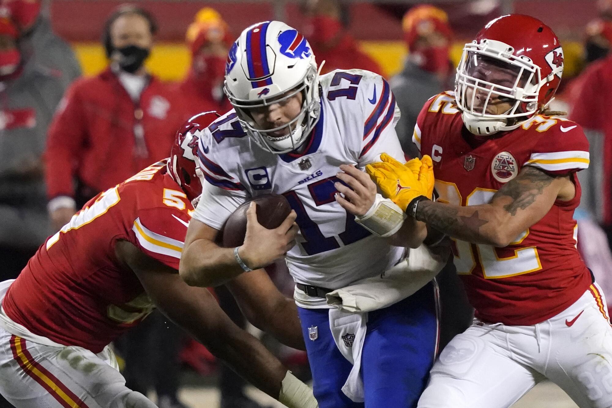 Buffalo Bills quarterback Josh Allen is tackled by Kansas City Chiefs safety Tyrann Mathieu.