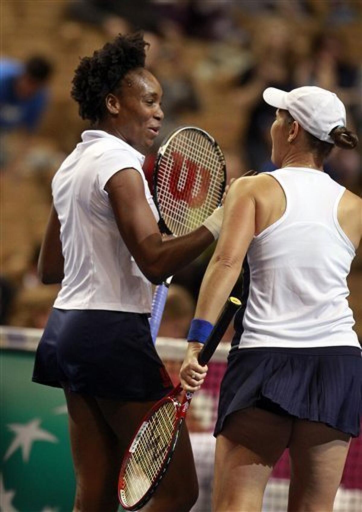 Venus Williams, left, celebrates after she and teammate Liezel Huber, right, defeated Anastasiya Yakimova and Darya Kustova, both of Belarus, during a doubles first-round Fed Cup tennis match in Worcester, Mass., Sunday, Feb. 5, 2012. The United States defeated Belarus 6-1, 6-2. (AP Photo/Steven Senne)