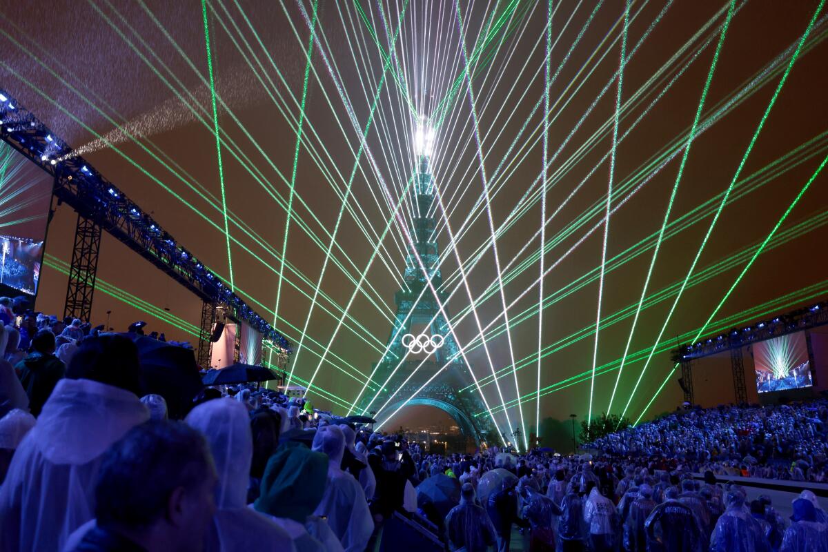 A light show is projected from the Eiffel Tower during the Paris Olympics opening ceremony Friday.
