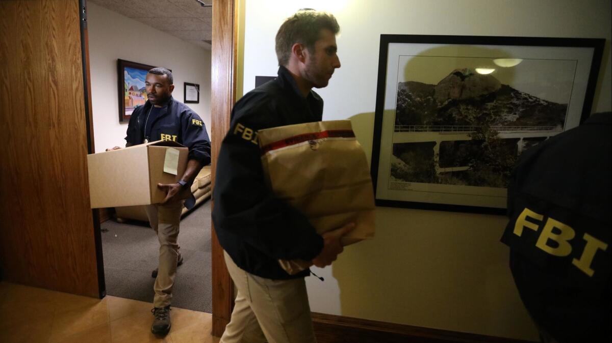 FBI agents carried bags and boxes of materials from the City Hall office of Los Angeles City Councilman Jose Huizar on Nov. 7.