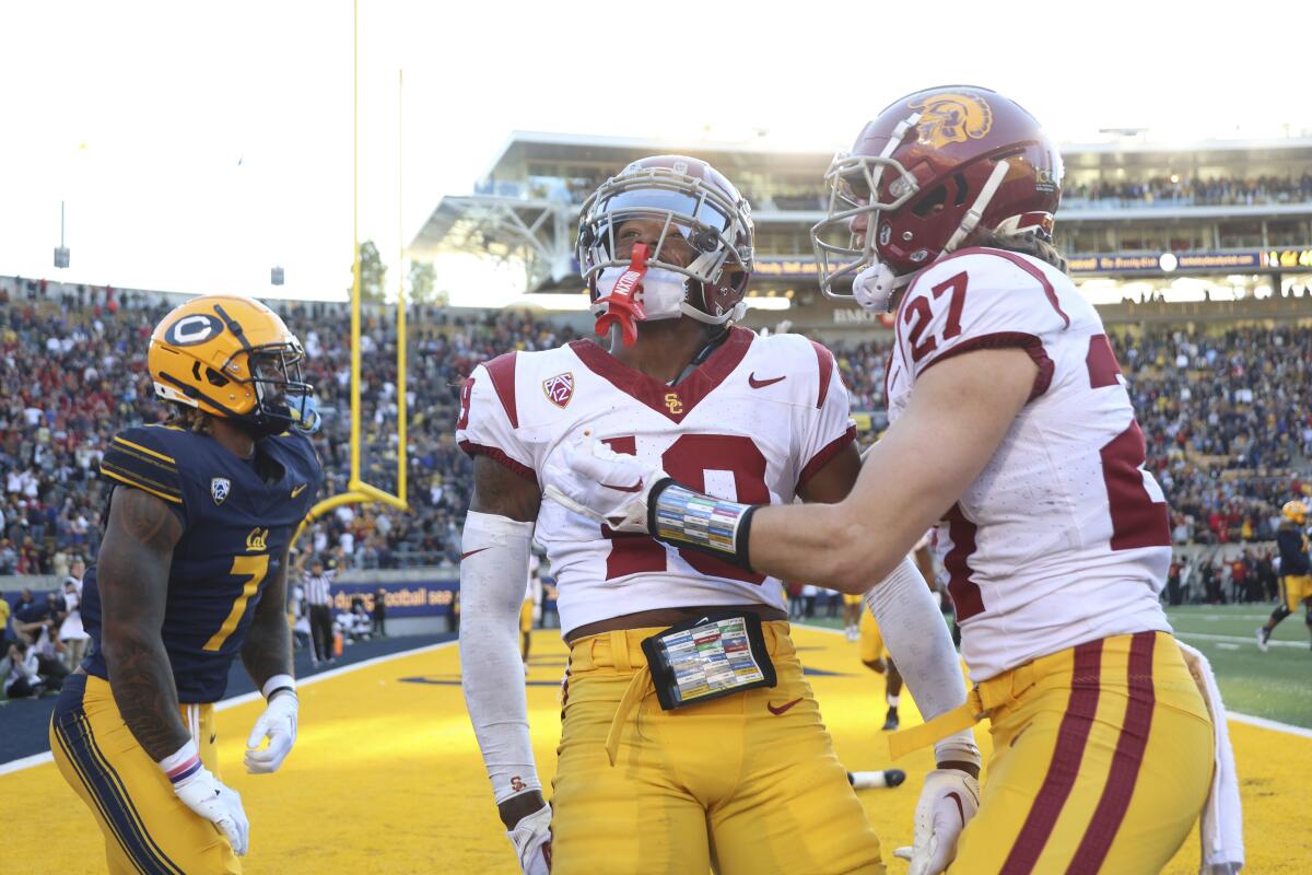 USC defensive end Jamil Muhammad, left, celebrates with safety Bryson Shaw.