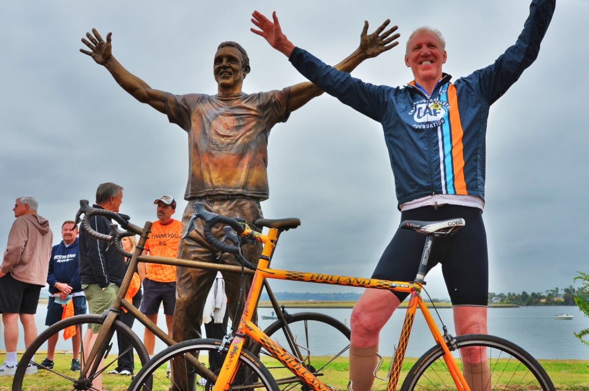 Former basketball star and colorful ESPN personality Bill Walton stands next to his bronze likeness. The cycling enthusiast is inviting people to take part in a Bike for Humanity solo ride event between 9 and 11 a.m. April 25 to benefit several COVID-19-related charities.