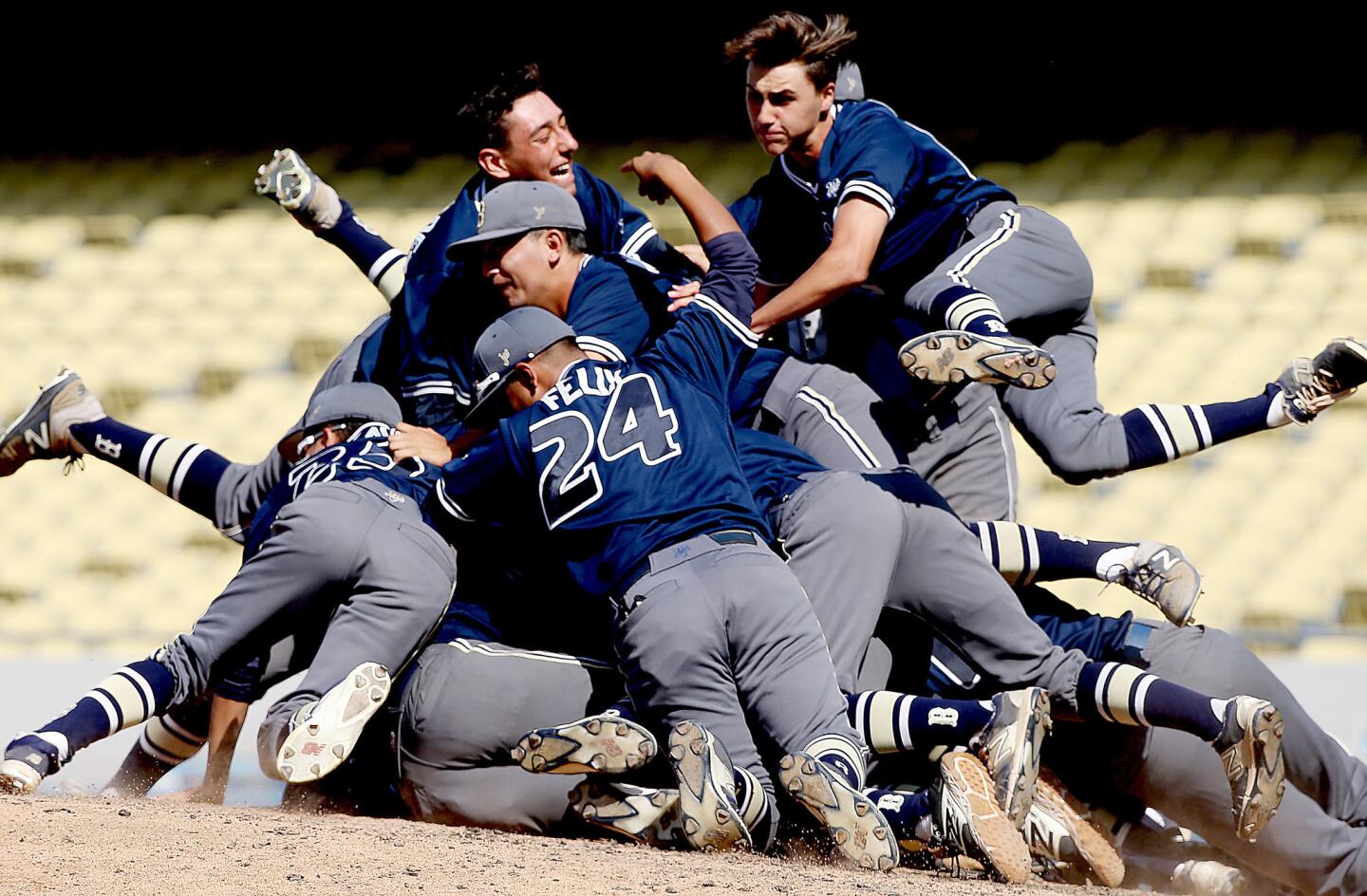 Birmingham Patriots players celebrate their 4-3 victory over Chatsworth with a dogpile on the mound at Dodger Stadium.
