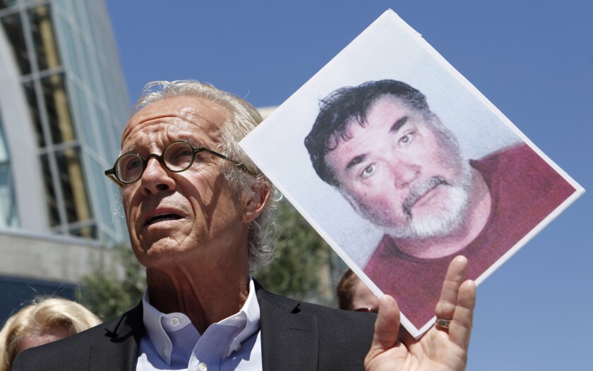 FILE - Attorney Jeff Anderson holds up a photo of former priest Stephen Kiesle at a news conference in Oakland, Calif., Wednesday, Aug. 18, 2010. The family of the late Jim Bartko, who said he was molested as a child by Kiesle, has filed a lawsuit against the Roman Catholic church under a new California law that allows family members of sex abuse victims to bring lawsuits after their deaths. The family of Bartko filed the suit in January 2022 in Alameda County Superior Court against the Diocese of Oakland. (AP Photo/Jeff Chiu, File)
