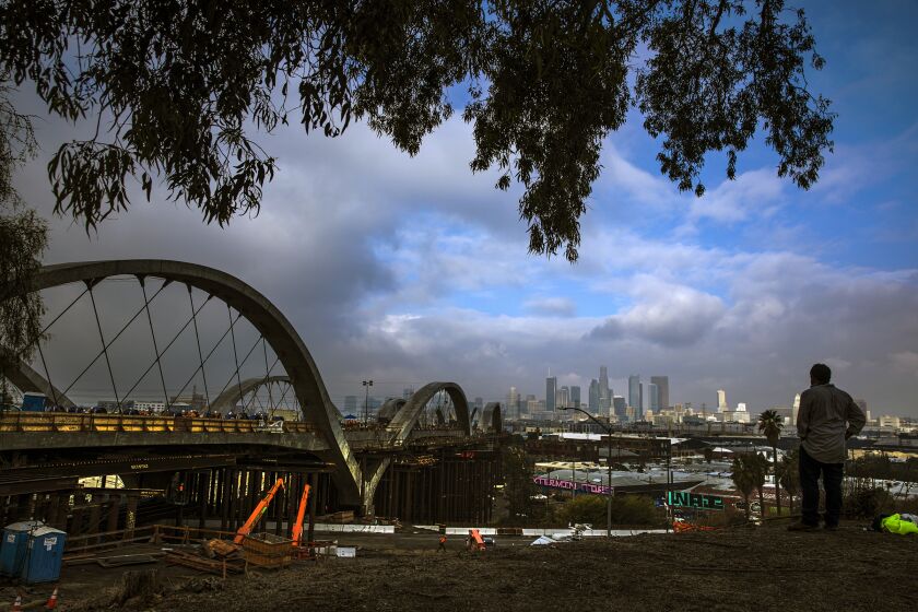 Los Angeles, CA - October 23: A view of the bridge from top while underneath crew removes falsework under the viaduct at Sixth Street bridge on Saturday, Oct. 23, 2021 in Los Angeles, CA. (Irfan Khan / Los Angeles Times)