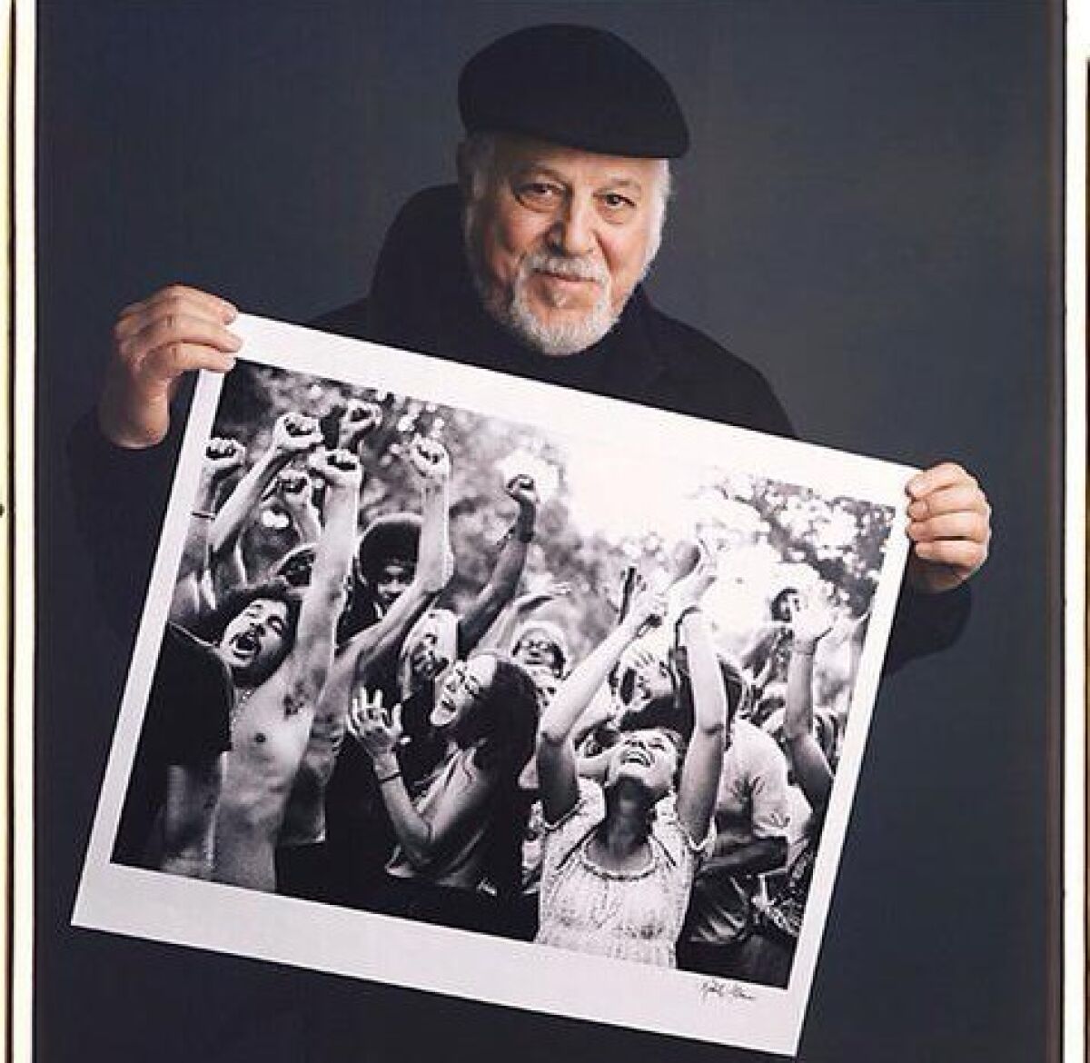 Robert Altman poses with an image from his book 'The Sixties: Photographs.'
